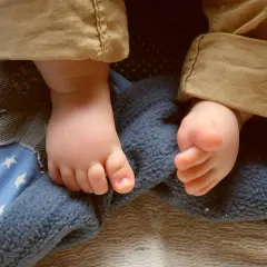 Piedini di bimbo su coperta stellata, pronti per dolci storie per bambini per dormire.