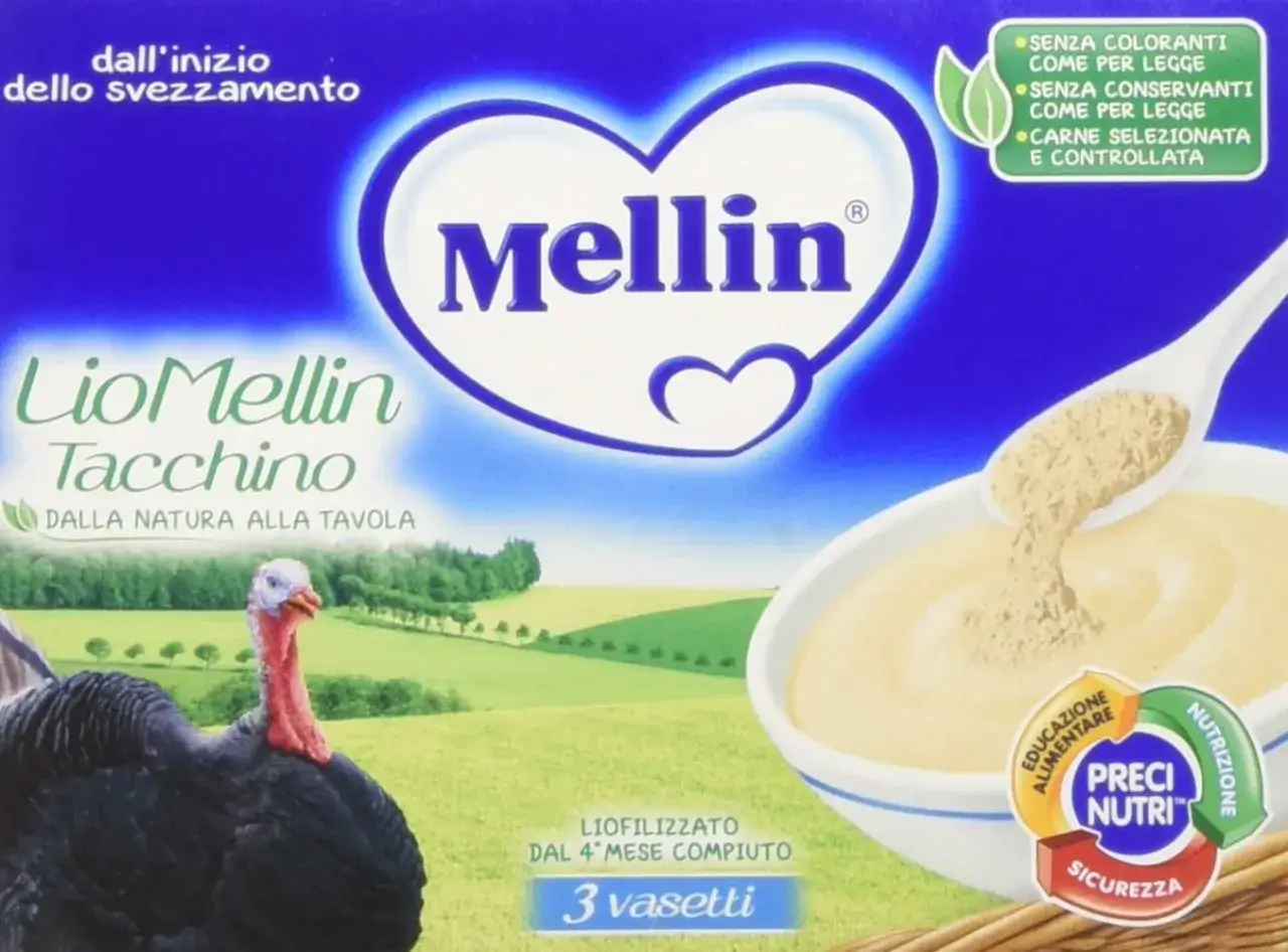 Confezione di LioMellin Tacchino, liofilizzato di carne per lo svezzamento, con tacchino in primo piano e un campo verde sullo sfondo.